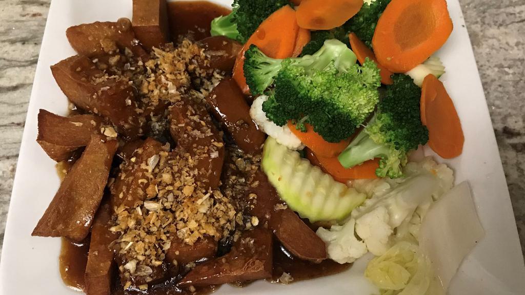 Garlic Sensation · Veg protein sauteed in garlicky brown sauce, topped with crispy garlic. Served with steamed vegetables.