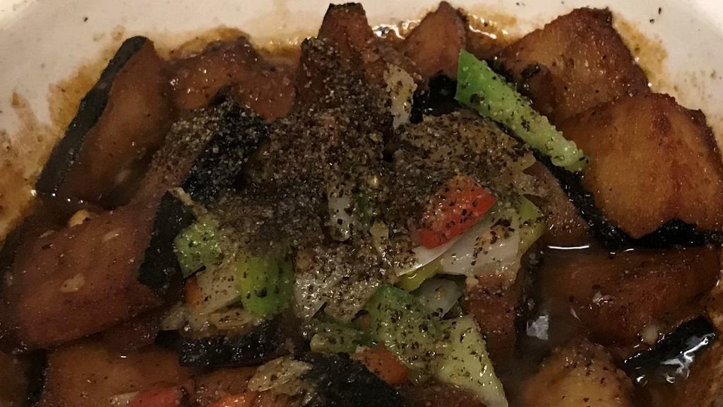 Clay Pot · Spicy. Seaweed-wrapped veg protein simmered in a thick pepper sauce with bell pepper and onion. Garnished with scallions.