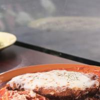 Chicken Parmesan · Breaded crispy chicken breast served over spaghetti and pomodoro sauce.