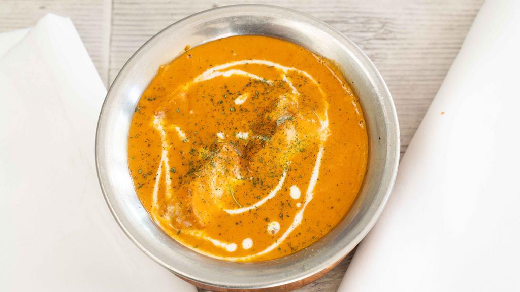 Butter Chicken · Boneless chicken cooked in butter with spices, cream and almonds.