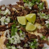 4 St Tacos W/Onion & Cilantro · 4 CORN TORTILLAS STREET TACOS SERVED WITH CARNE ASADA, ONION & CILANTRO