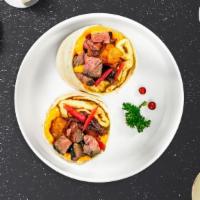 Loco Moco Breakfast Burrito · Ground sirloin, grilled mushrooms, eggs over easy, Hawaiian-style gravy, sliced green onions...