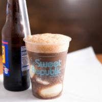 Root Beer Float · Root beer in a glass bottle with two scoops Vanilla Bean ice cream