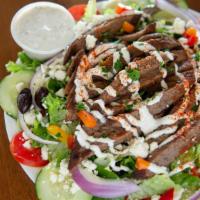 Gyro Salad · Sliced gyro meat (mixture of lamb and beef) served on Greek salad and side of house tzatziki...