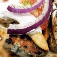 Chicken Souvlaki · Grilled chicken breast served with Greek salad, pita bread, side of house tzatziki sauce.