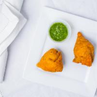 Vegetable Samosa · Crisp, savory pastries filled with spiced potatoes and green peas.