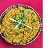Baingain Bharta · Clay oven roasted eggplant cooked with hand pounded spices and herbs. (GF)
