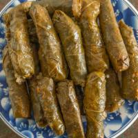 Grape Leaves · Grape leaves stuffed with rice, tomatoes, onions, parsley, and a hit of lemon juice, topped ...