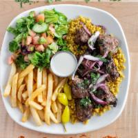 Beef Kabob Plate · Top sirloin. Two skewers of grilled beef kabob on top of fluffy white rice, topped with onio...