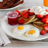 Fresh Strawberry Pancakes · Our aged buttermilk batter with fresh strawberries and whipped cream on the side. Served wit...