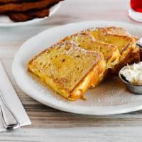 Sourdough French Toast · Thick sourdough bread dipped in a seasoned egg batter. Served with a side of maple syrup, wh...