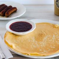 Swedish Pancakes · Three thin and lacy pancakes, made to roll. Served with a side of lingonberries and whipped ...