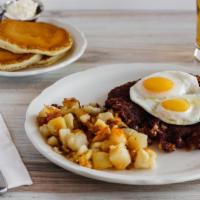 Corned Beef Hash & Eggs · Slow-roasted corned beef brisket, ground in-house with onions, potatoes and seasonings, cook...