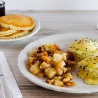 Classic Eggs Benedict · Two slices of hickory smoked canadian bacon on a grilled english muffin, topped with two poa...