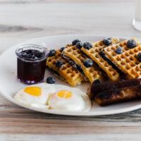 Blueberry Waffle · Baked with blueberries and sprinkled with powdered sugar. Served with a side of fresh bluebe...