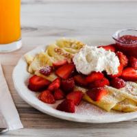 Fresh Strawberry Crepes · Three delicate crepes filled and topped with freshly cut strawberries and a side of whipped ...