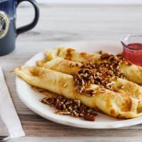 Apple Crepes · Three delicate crepes filled with sour cream, pecans and chopped apples, tempered with tripl...