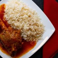 Lamb Shank Qurma · Boneless lamb cooked with onions, garlic, ginger, tomatoes, and spices served with rice.