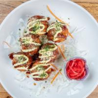 Takoyaki · Deep-fried octopus balls, topped with bonito flakes, pickled ginger, and seaweed flakes with...