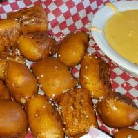Pretzel Sticks · Warm pieces of pretzel dough baked to a golden brown and lightly salted. Served with our spi...