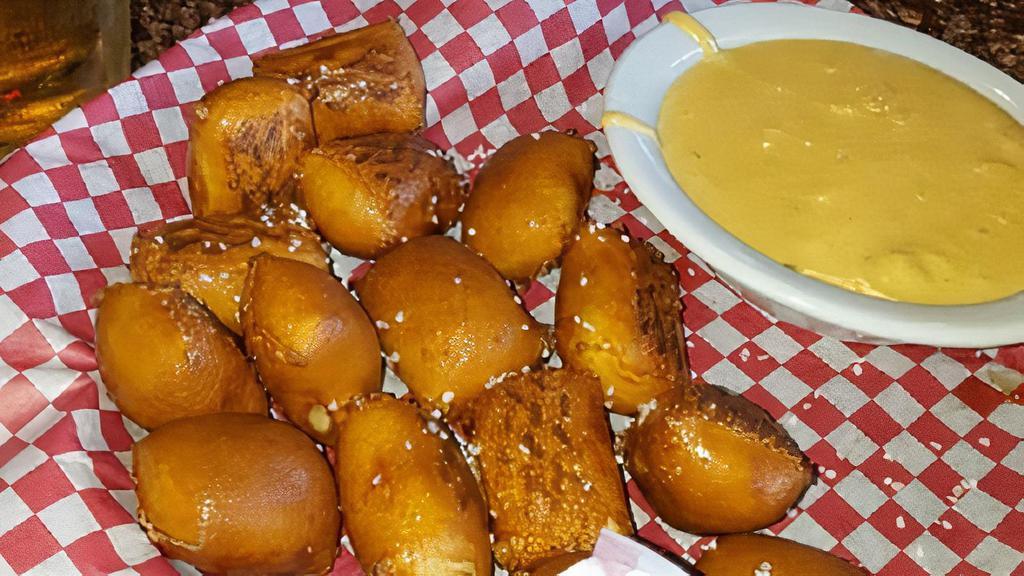 Pretzel Sticks · Warm pieces of pretzel dough baked to a golden brown and lightly salted. Served with our spicy beer queso.