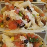 Fish Tacos · Beer-battered fried fish, corn or flour tortillas, Napa cabbage, black bean corn salsa, chip...