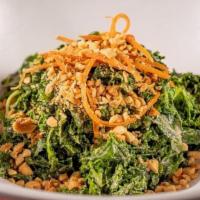 Kale Salad In Sesame Dressing · Blanched Kale tossed with sesame dressing, topped off with shredded carrots and a sprinkle o...