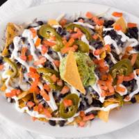 Nachos · Served with tortilla chips, cheese, black beans, sour cream, guacamole, tomatoes, and pickle...
