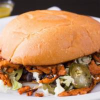 Torta · Mexican sandwich with choice of meat, butter, beans, mayonnaise, jalapeño, grilled onion, an...