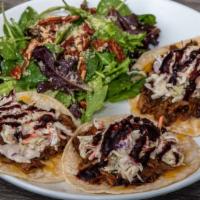 Blackberry Ancho Pulled Pork Tacos · Corn Tortilla, Jack and Cheddar Cheese, House made Slaw.