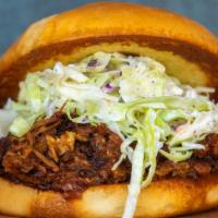 House Smoked Pulled Pork Sandwich · House Smoked Pulled Pork, Blackberry Ancho Sauce, Coleslaw.