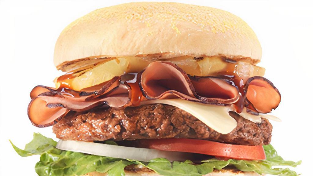 Hawaiian Teriyaki Burger · Broiled Pineapple Slices Glazed with Teriyaki Sauce over Thinly Sliced Black Forest Ham and Swiss Cheese on top of a 1/4lb Ground Beef Patty, Freshly Sliced Tomatoes, Lettuce, and Onions on a Cornmeal Topped Bun.