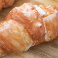 Cream Filled Croissant · Delicious flaky croissant filled with light Bavarian cream and dunked in a sweet glaze.