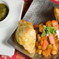 Vegetable Samosa · Two crispy pastries stuffed with potatoes and peas, served with channa masala.