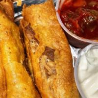 Chicken Taquitos 3 Pcs · Large rolled tacos served with chile con queso.