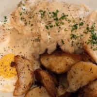 Biscuits & Gravy · Two eggs, two freshly baked biscuits, covered in country gravy.