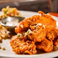 Buffalo Chicken Tender Platter · Buttermilk marinated chicken tenders tossed in medium buffalo sauce with couscous, French fr...
