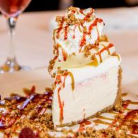 White Chocolate Raspberry Cheesecake · A creamy, soft raspberry infused cheesecake. Topped with fresh raspberries, whipped cream, a...
