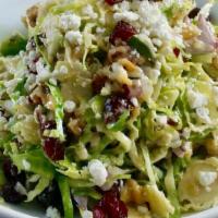 Brussels Sprout Salad · Dried cranberries, red onion, roasted pecans & goat cheese dressed with a Dijon vinaigrette