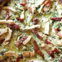 Chicken Pesto Pizza · Pesto sauce, mozzarella, grilled chicken, sun-dried tomatoes, sautéed onions & Parmesan