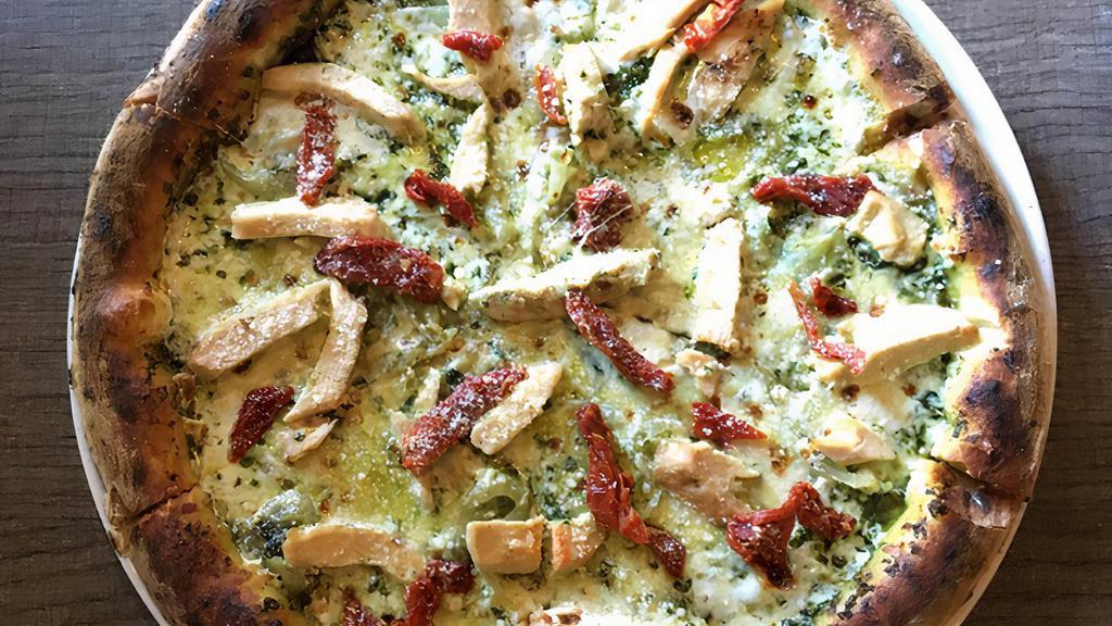 Chicken Pesto Pizza · Pesto sauce, mozzarella, grilled chicken, sun-dried tomatoes, sautéed onions & Parmesan