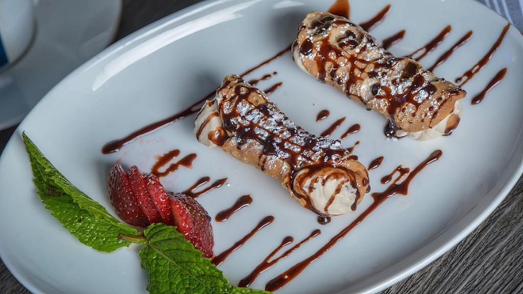 2 Mini Cannoli · Crispy Italian pastries filled with sweet chocolate chip ricotta, dusted with powdered sugar & drizzled with chocolate sauce