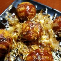 Takoyaki · A ball-shaped grilled and fried minced octopus and vegetable mix.
