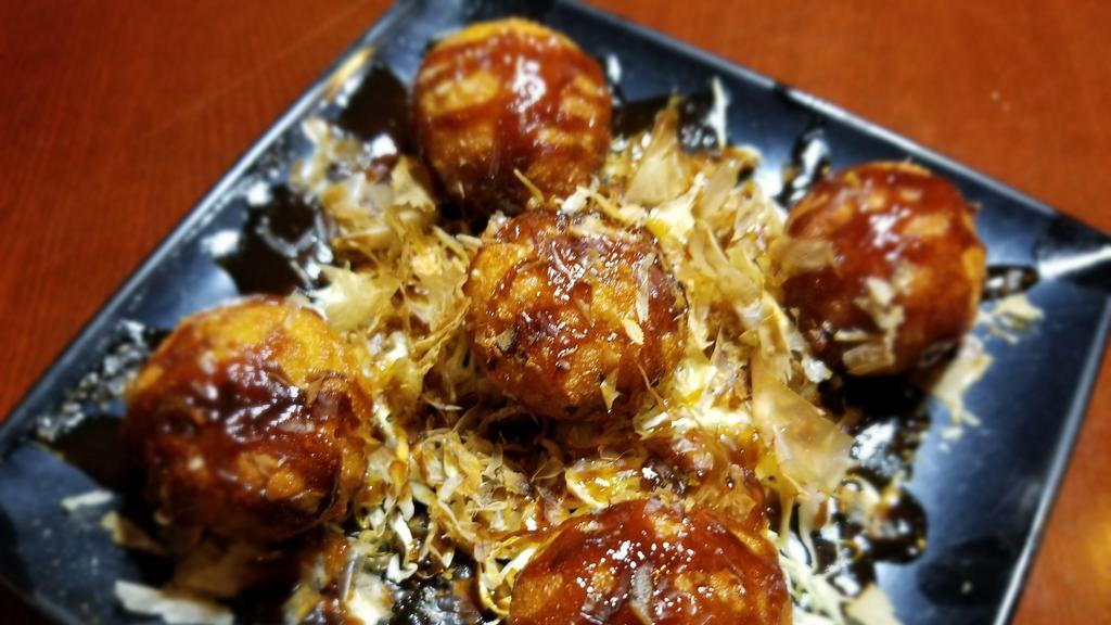 Takoyaki · A ball-shaped grilled and fried minced octopus and vegetable mix.