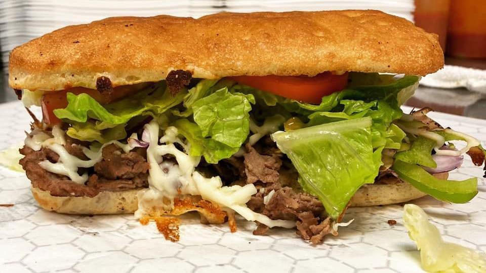 Steak & Cheese · Steak and cheese is served with green peppers, lettuce, mozzarella, mushrooms, onions, steak, tomatoes.