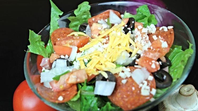 Chef Salad · Chef salad is served with cheddar cheese, croutons, green peppers, ham, lettuce, onions, tomatoes, turkey.