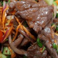 Beef Salad · Grilled tender beef mixed with tomatoes green onion red onion, cucumber, and cilantro, serve...