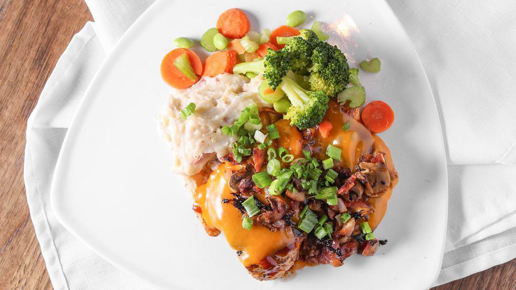 The Loaded Bird · BBQ grilled chicken topped with sharp cheddar cheese, applewood smoked bacon, onions, sauteed mushrooms and topped with green onion. Served with fresh sauteed mixed vegetables, and red skin mashed potatoes.
