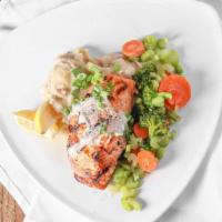 Broiled Lemon Salmon · Atlantic Salmon filet broiled with lemon butter served with red skin mashed potatoes and sau...