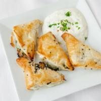 Spanikopita · Phyllo dough layered with a Lebanese spinach and feta mix. Served with tzatziki.